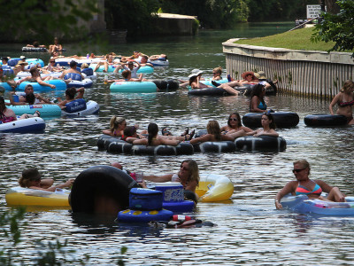 As the summer season gets rolling and with more people seeking relief from the heat as these tubers on the Comal River in New Braunfels are doing, Neil Suntych is not at a loss for people to photograph. Suntych has been shooting tubers for the past three years along the Comal. Tubers can see the pictures that Suntych has taken online and have the option of buying prints or digital downloads.